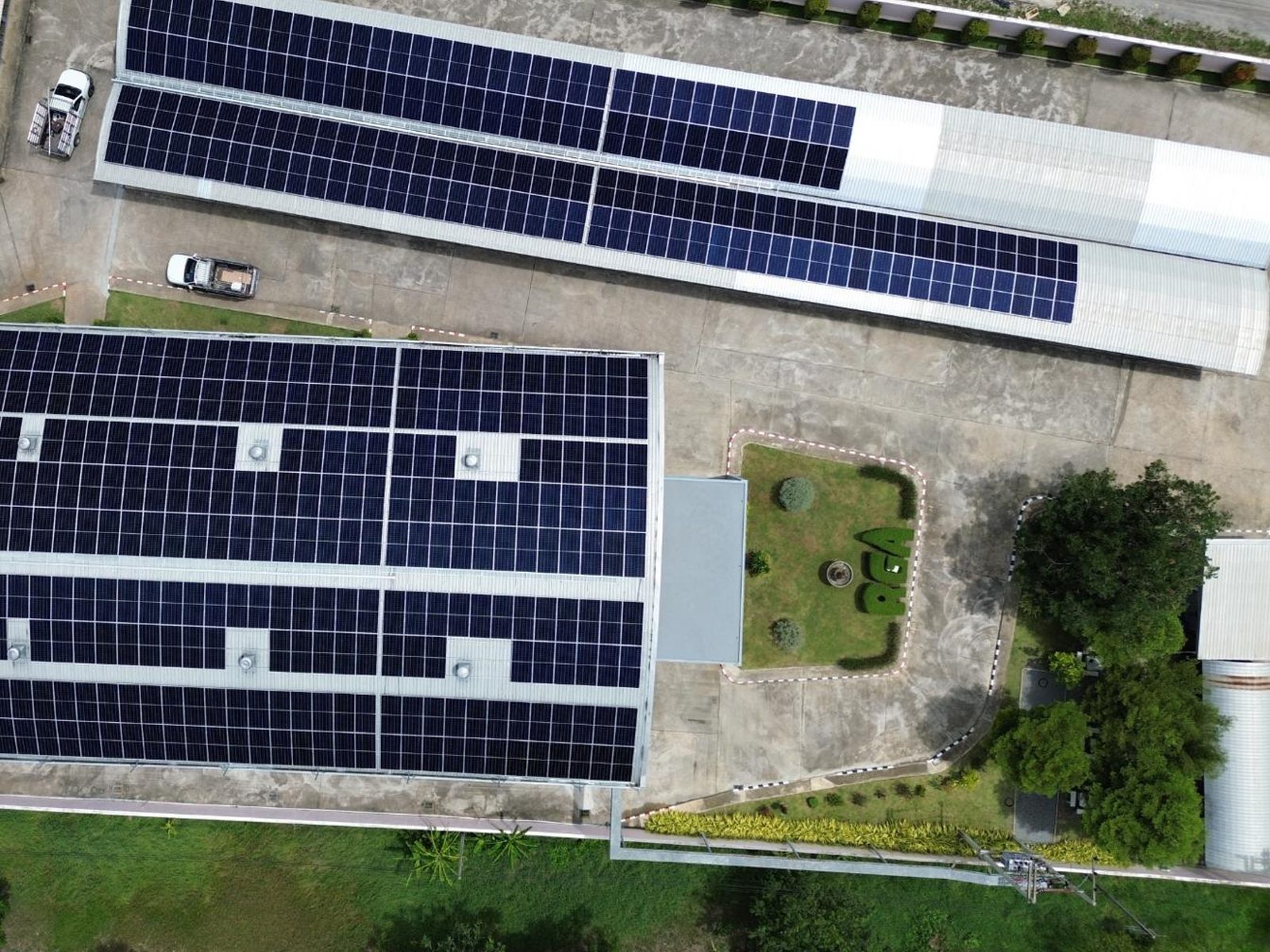 Aerial view of completed solar arrays across two factory buildings